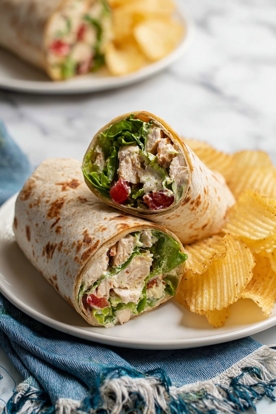 Chicken Caesar Wraps, Caesar Wraps Recipe, Easy Chicken Wraps, Healthy Chicken Wraps, Chicken Lunch Ideas - A round whole wheat tortilla lays flat on crumpled white parchment paper over a white marbled surface, topped with a single layer of mixed salad made of bright green Romaine lettuce pieces, creamy white cubed cooked chicken, small red grape tomatoes, and chunks of pale green avocado, all coated lightly in a creamy dressing. The textures of the lettuce are crisp, the chicken looks tender, and the tomatoes are smooth and shiny. photo taken with an iphone --ar 2:3 --v 7