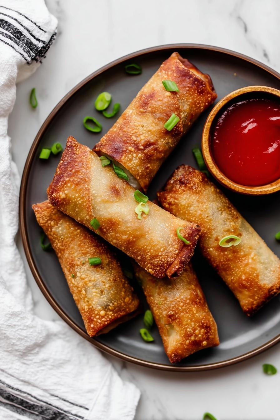 Turkey Egg Rolls with Crispy Filling, turkey egg rolls recipe, healthy egg roll ideas, easy crispy egg rolls, savory turkey appetizer - The image shows five golden-brown crispy egg rolls arranged on a round white plate with a dark rim. The egg rolls have a bubbly, crunchy texture with slightly darker, browned edges. They are garnished with small green onion pieces scattered around and on them. A small wooden bowl with bright red dipping sauce sits on the right side of the plate. The plate is placed on a white marbled surface with a white fabric napkin with black stripes near it. The photo taken with an iphone --ar 2:3 --v 7