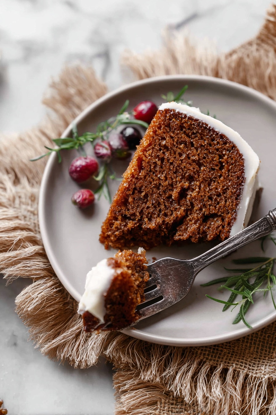 Gingerbread Bundt Cake with Maple Glaze, gingerbread fall desserts, holiday spice cake, moist ginger cake, cozy winter baked goods - A single round slice of brown cake with a soft and moist texture is placed on a white plate. The cake has a thin layer of light frosting around the edge. A piece of the cake is cut and held on a silver fork with a dark handle, resting on the plate. The plate also holds some small red and dark red berries and a green herb sprig as decoration. The plate is set on a tan fringed cloth, all on a white marbled surface. Photo taken with an iphone --ar 2:3 --v 7