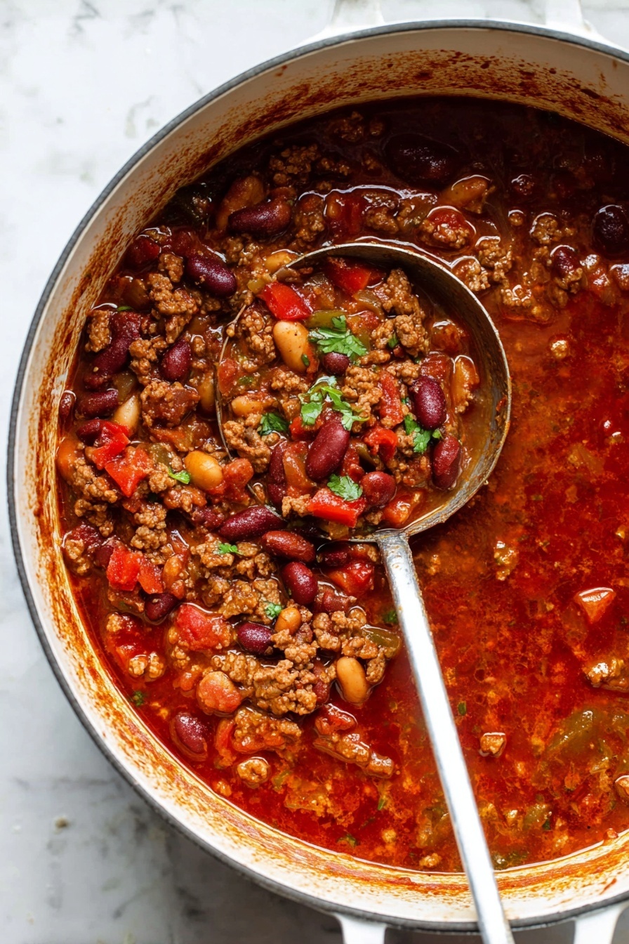 Best Ever Beef Chili, hearty beef chili, easy chili recipe, homemade beef chili, flavorful chili - Inside a round white pot, there is a thick chili mixture. The dish has many layers: a red tomato sauce base, chunks of red bell peppers, light brown cooked ground meat, beige and dark red beans, and bits of translucent onions and green celery. The chili looks juicy with some shiny spots of oil and small green cilantro pieces sprinkled on top. A metal ladle with a worn handle rests in the pot, filled with the chili showing all these layers closely. The pot is on a white marbled surface, and the edges of the pot have splashes of the red sauce around the top. Photo taken with an iphone --ar 2:3 --v 7