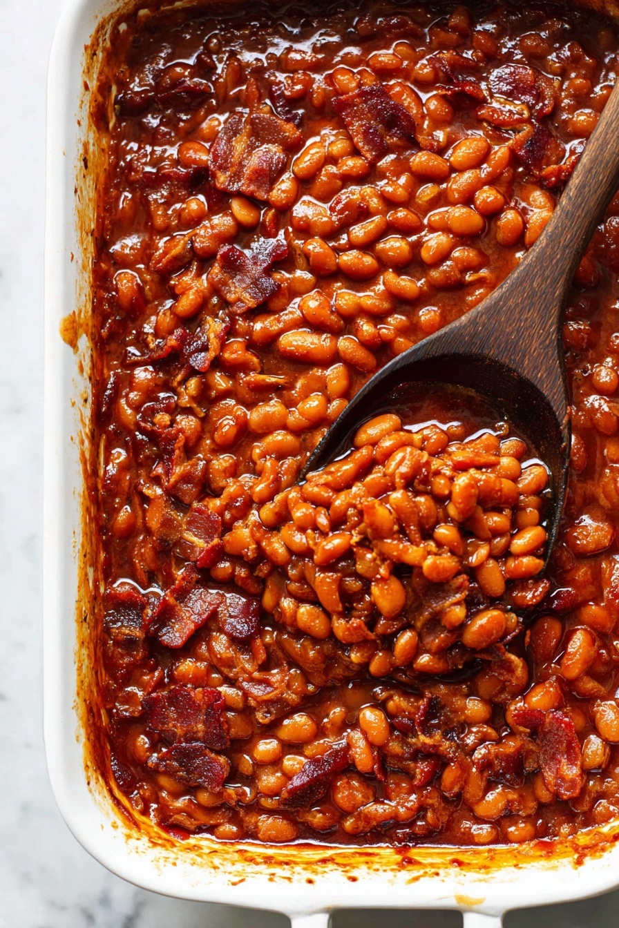 Best Baked Beans, baked beans recipe, smoky baked beans, hearty side dishes, easy baked beans - The image shows a close-up of a wooden spoon lifting a thick, rich stew full of small brown beans and pieces of crispy bacon in a shiny, reddish-brown sauce. The stew is held in a white baking dish sitting on a white marbled surface. The beans and bacon pieces are mixed evenly through the sauce, creating a textured and hearty appearance with glossy highlights on the beans and sauce. The wooden spoon is held just above the dish, showing the dense, saucy mixture in detail. Photo taken with an iphone --ar 2:3 --v 7